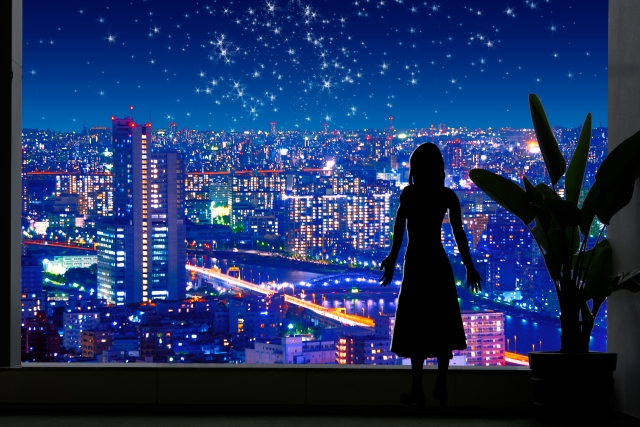 大きな窓 都会の夜景と星空