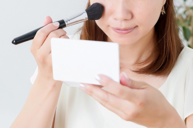 A woman putting on makeup