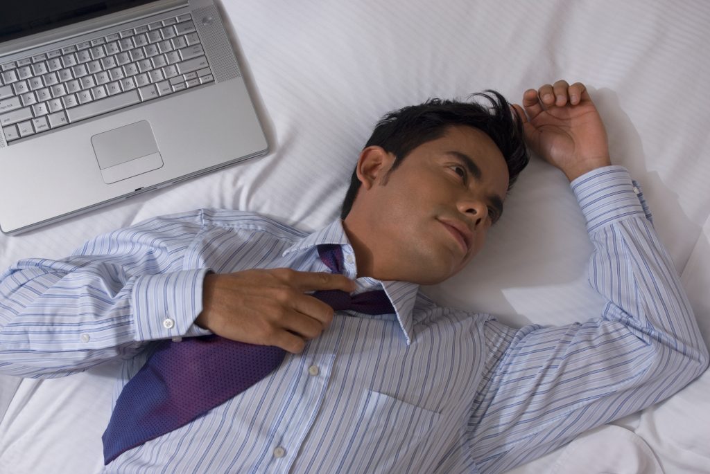 businessman laying on bed